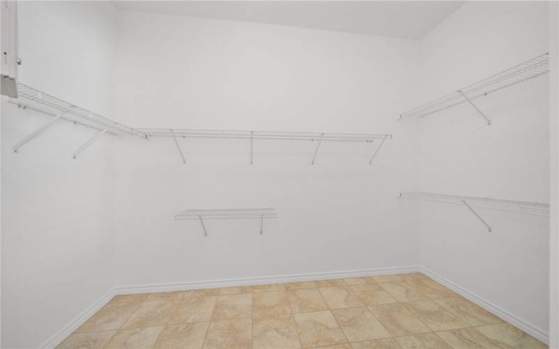 Walk-in closet in primary bathroom