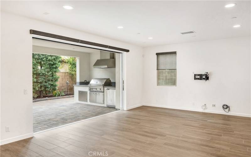 Family room with multi-panel pocket doors to outdoor room.