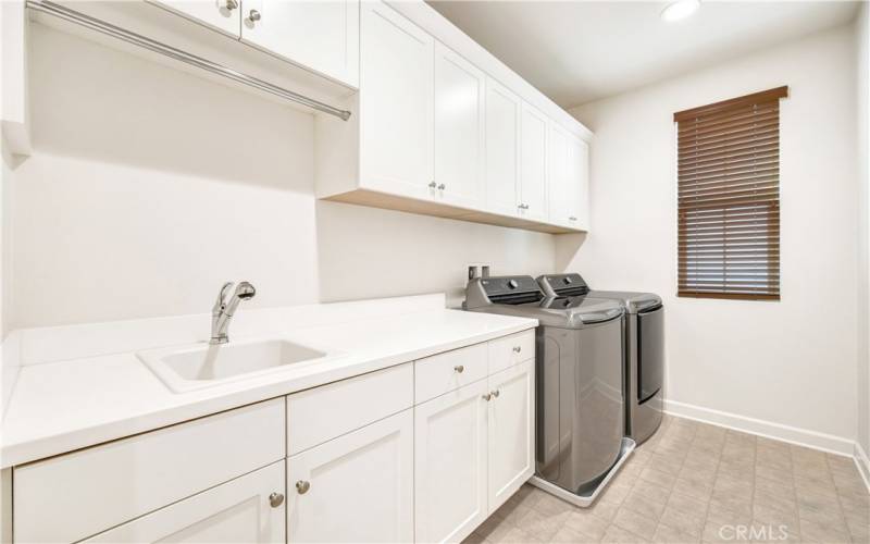 Upstairs laundry room with lots of storage.