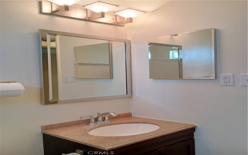 granite counter in the bathroom and newer light features