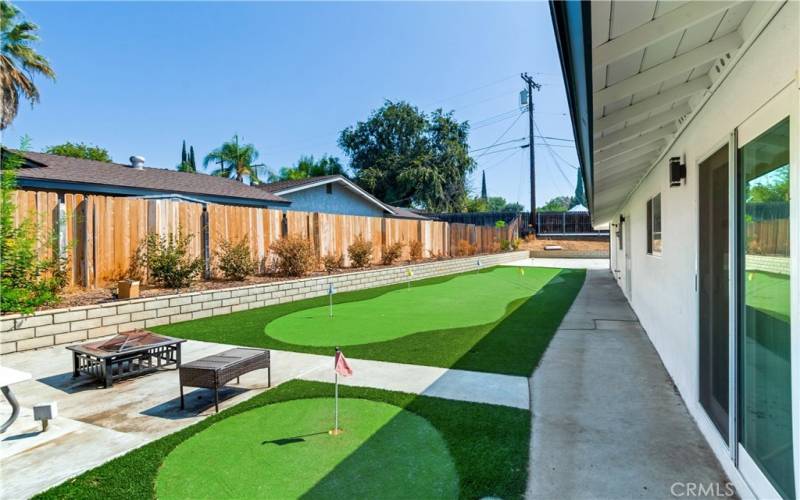 This is another view of the backyard, which includes a putting green. However, the putting green can easily be transformed into whatever your backyard needs.