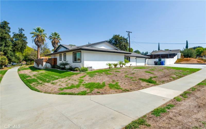 This is a view of the corner of the property from the outside. It shows the corner and some of the surrounding area.