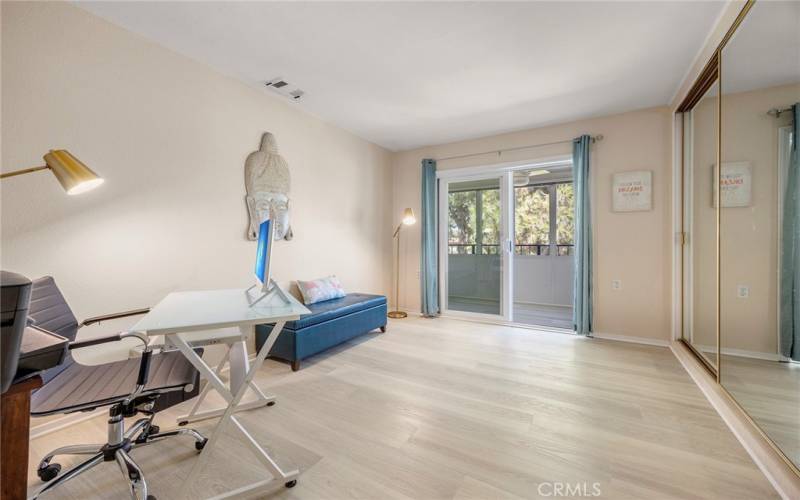 SECOND BEDROOM WITH MIRRORED CLOSET DOORS AND SLIDING DOORS TO BALCONY