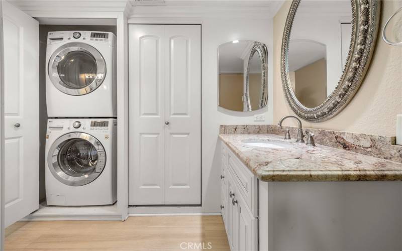 PRIMARY BATHROOM WITH STORAGE CLOSET AND STACKED WASHER AND DRYER