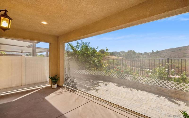 Covered patio with 3 independently controlled shades, operated by remote control providing sun protection. VIEWS!