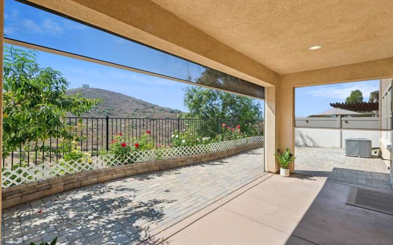 Covered patio enclosed by 3 independently operated remote controlled shades. Views!