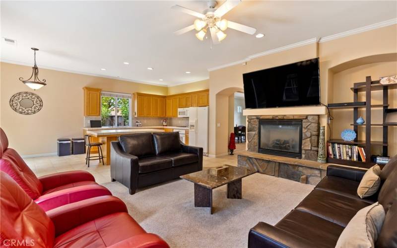 Living room with mounted tv on top of fireplace