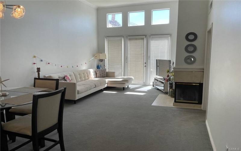 living room with high ceiling and fireplace