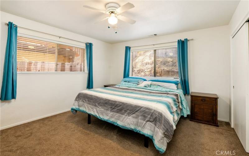 The primary bedroom offers a ceiling fan, newer carpet (~ 4 years new) and two windows to usher in the natural light.