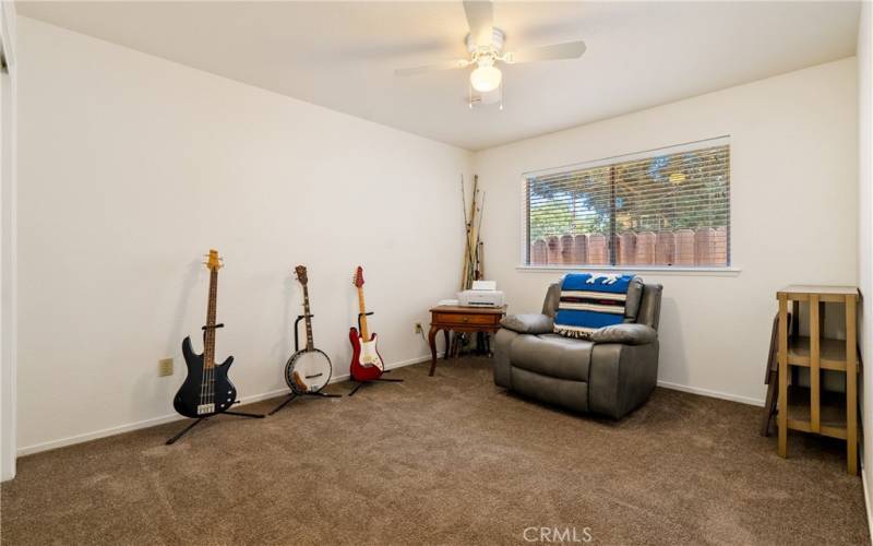 Bedroom 2 features a ceiling fan and newer carpet.