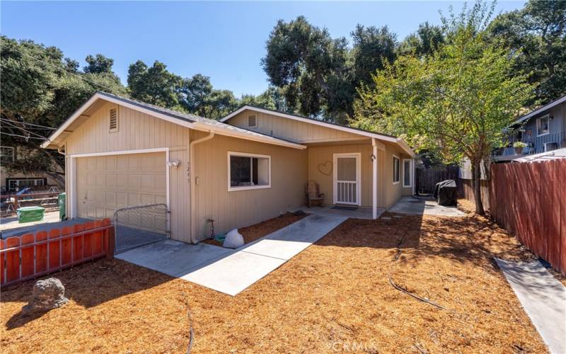 Low maintenance landscaping and fenced yard brings you to the front door.