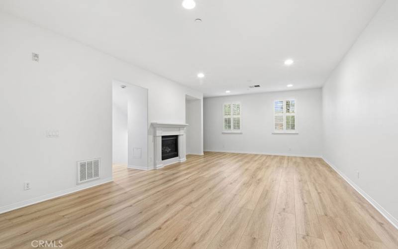 Second level great room with gas fireplace and new, just installed LVP flooring.