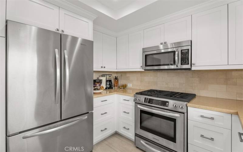 Upgraded kitchen with stainless steel suite of appliances, granite counters, and lake views.