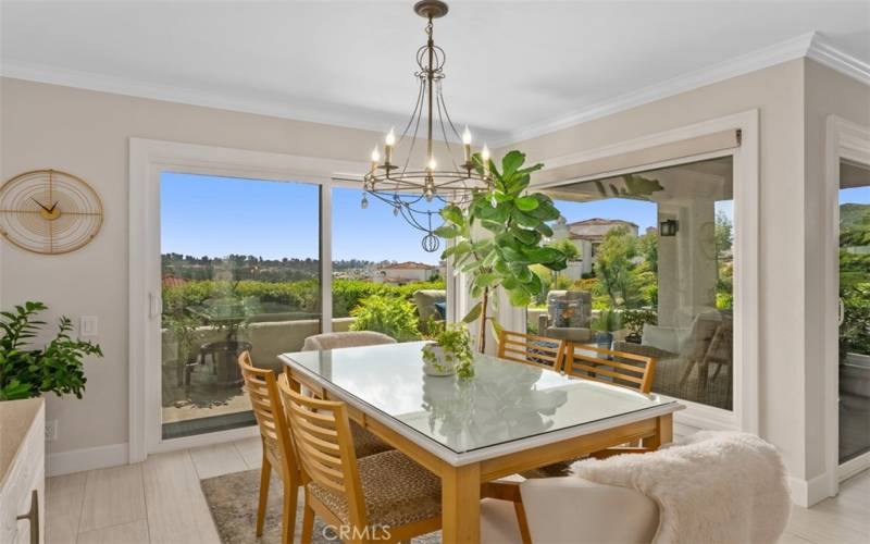 Dining enclave has open floor plan feel with natural lighting, newer flooring, and amazing views.