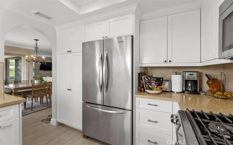 Upgraded kitchen with stainless steel suite of appliances, granite counters, and lake views.