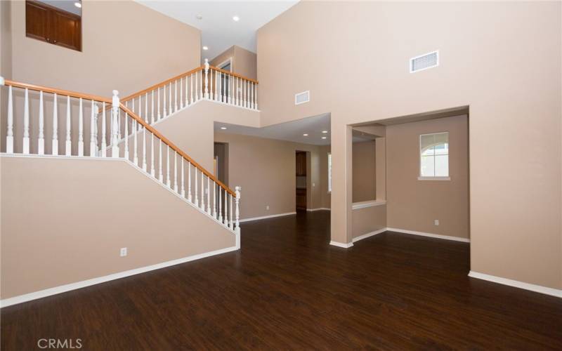 Spacious living room with a view of the entrance, dining area,  and second floor