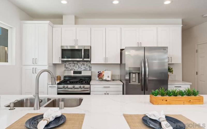 You are looking at all new upgraded appliances and Quartz Counters which allow for four people to  snuggle up to counter and watch the chef prepare that next meal.