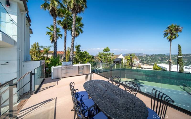 Outdoor dining over tennis, view of Hollywood Sign