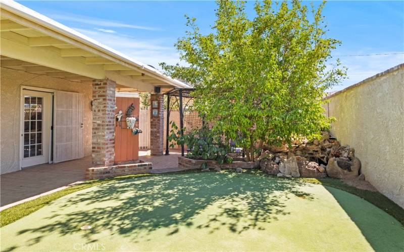 Backyard with putting green and koi pound