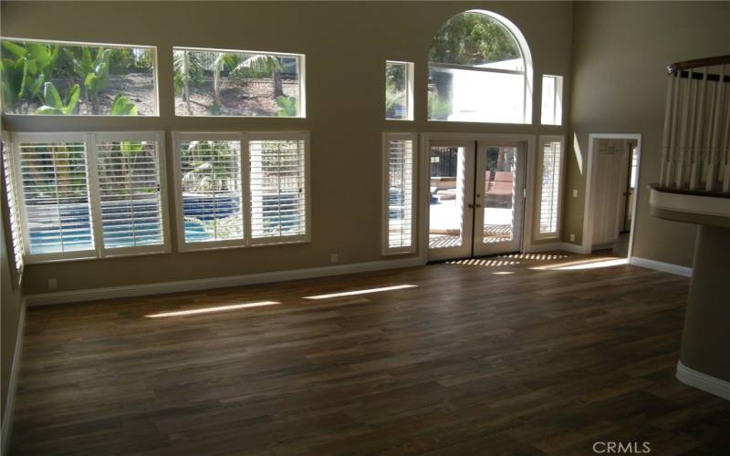 Formal living room and dining room with vaulted ceilings