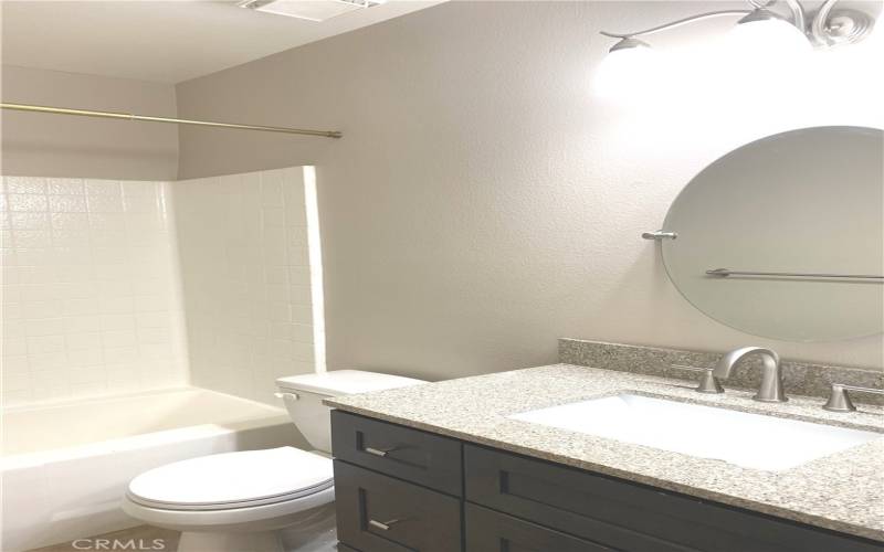 Second bathroom also has a shower over the tub.