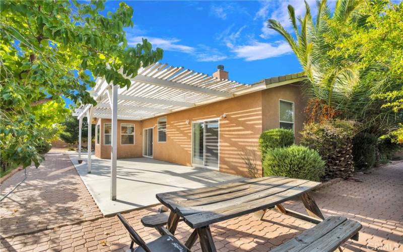 Large covered patio area which leads to a large uncovered patio area as well as all of this paved area.