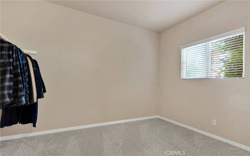 Primary suite dressing room with natural light.