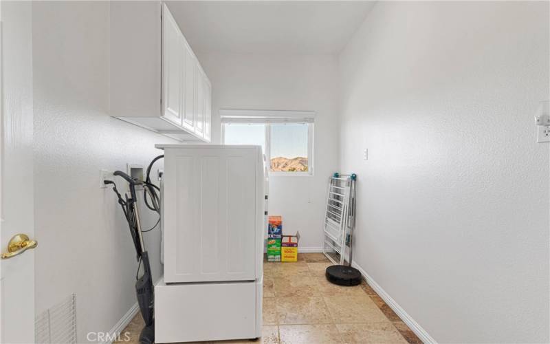 Large laundry room with storage and overlooking the desert floor.