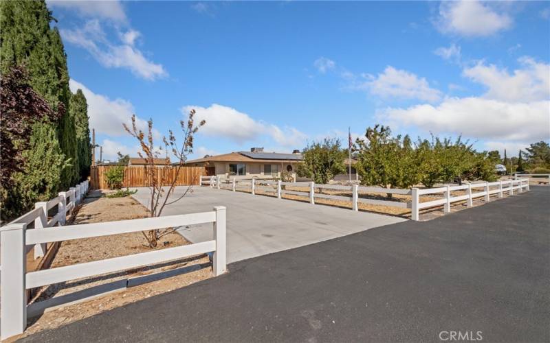 Concrete parking pad on the south side of house for extra RV, toy trailer