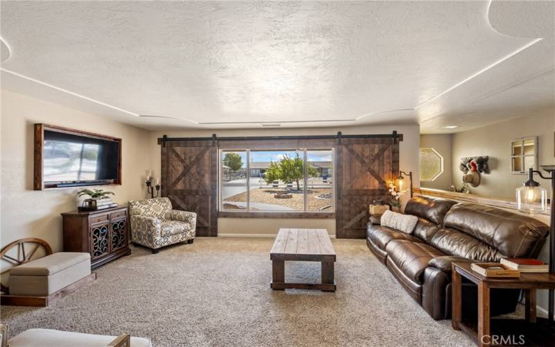 Main house living room, custom barn doors for front windows.