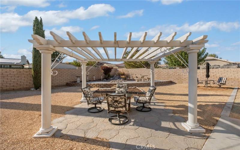 This pergola creates visual interest for the space while allowing you to enjoy the Beautiful Firepit surrounded by your favorite seating.