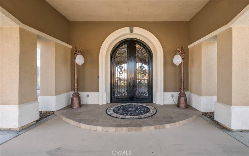 Under the Porte Chochere to the to the Foyer through the dramatic Iron and Glass double doors.