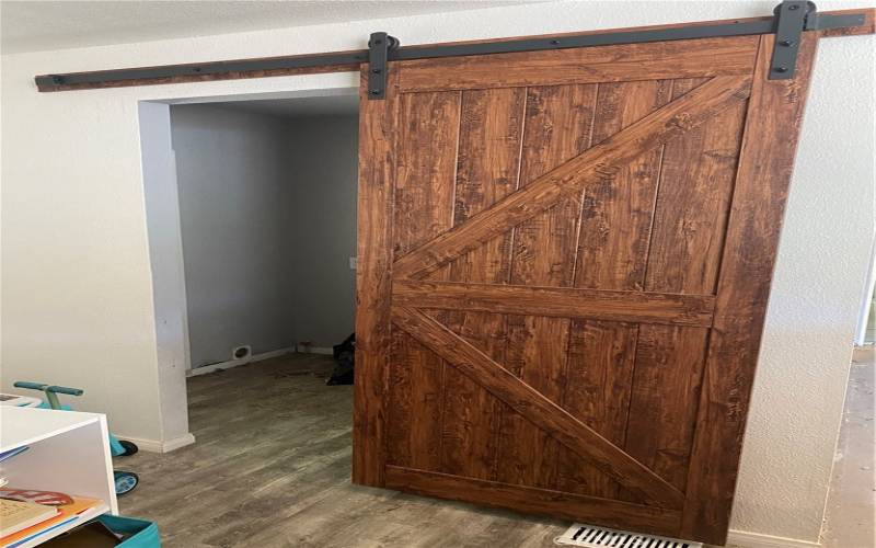 Barn door in kitchen to laundry room