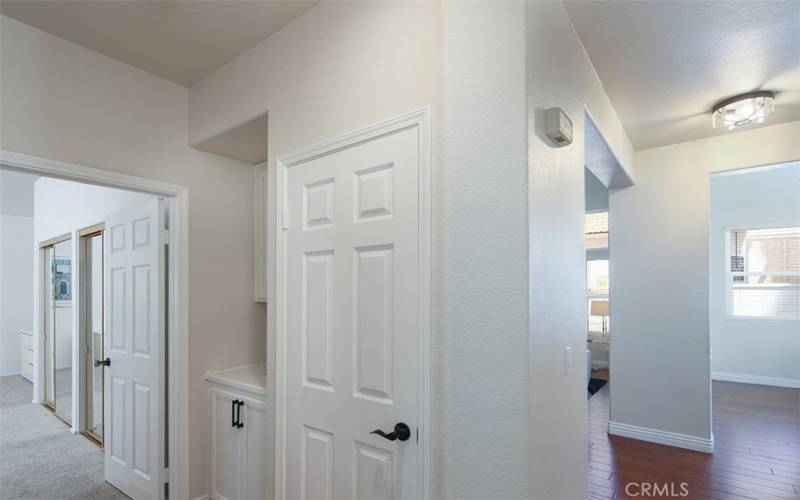 Entrance closet with view to main bedroom on the left, living room to the right