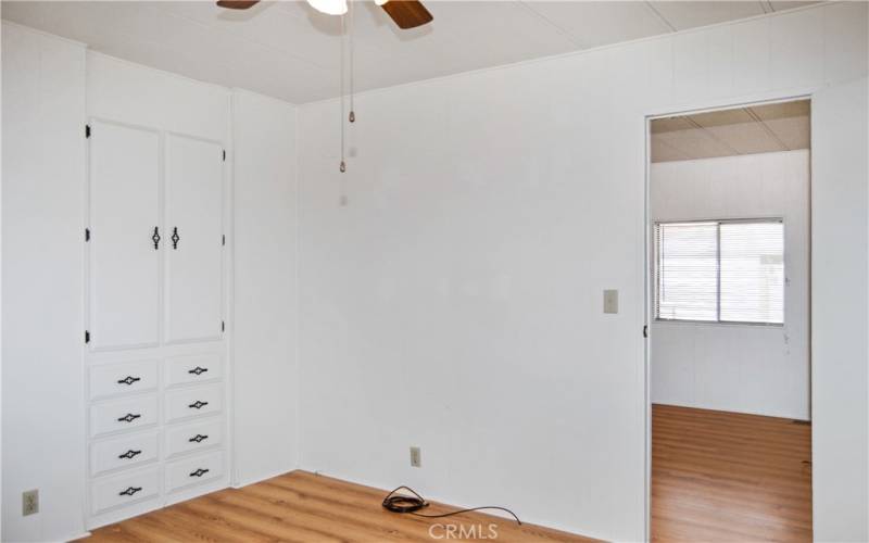 The 2nd bedroom has direct access to the 2nd bath, built-in cabinetry, a walk-in closet, and a ceiling fan which make it feel like another primary suite.