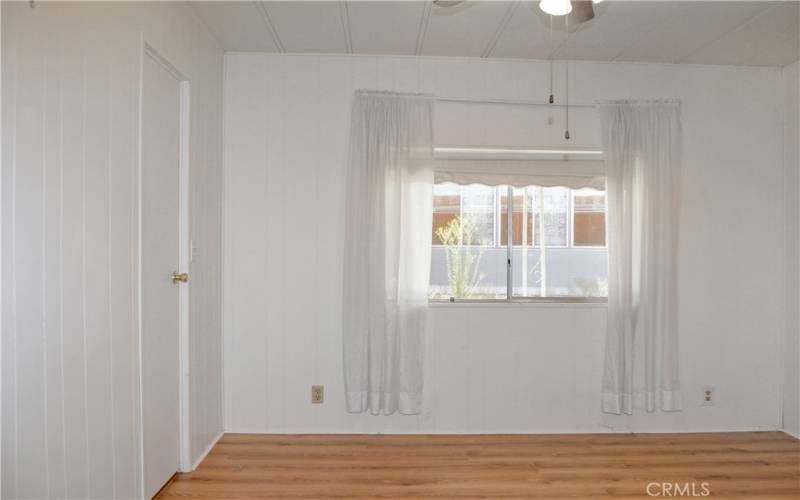 The 2nd bedroom has direct access to the 2nd bath, built-in cabinetry, a walk-in closet, and a ceiling fan which make it feel like another primary suite.