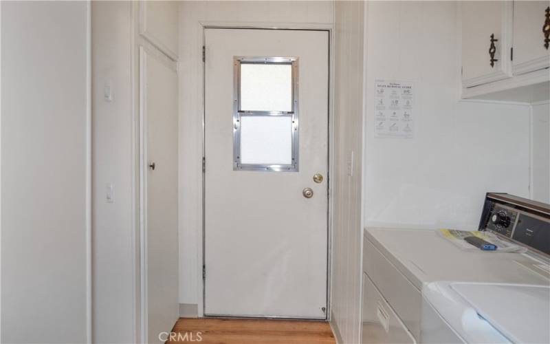 Laundry room with washer and dryer included, lots of storage in the cabinets and closet, and carport access