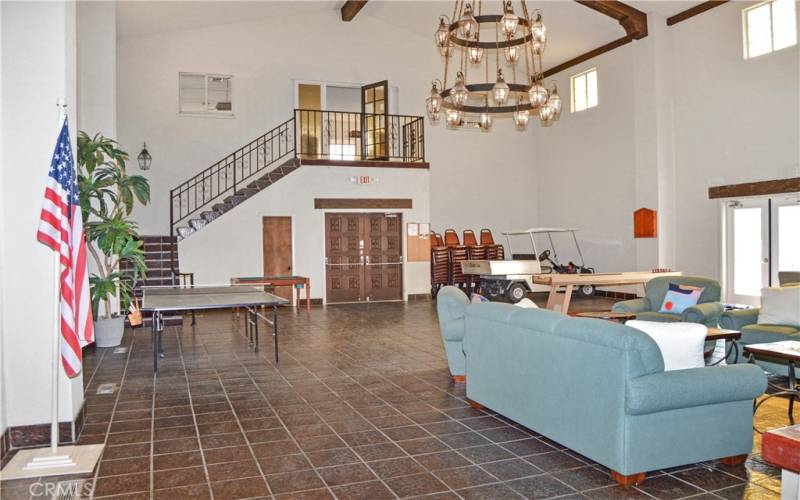 Clubhouse with impressive chandelier, numerous games (ping pong, bumper pool, darts, shuffleboard, and cornhole) were all out for residents to use in this space. The billiards room is up the stairs.