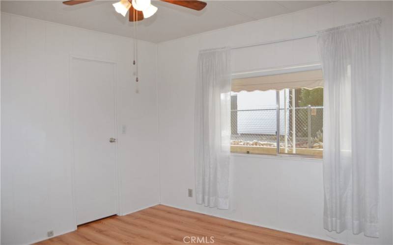 The 2nd bedroom has direct access to the 2nd bath, built-in cabinetry, a walk-in closet, and a ceiling fan which make it feel like another primary suite.