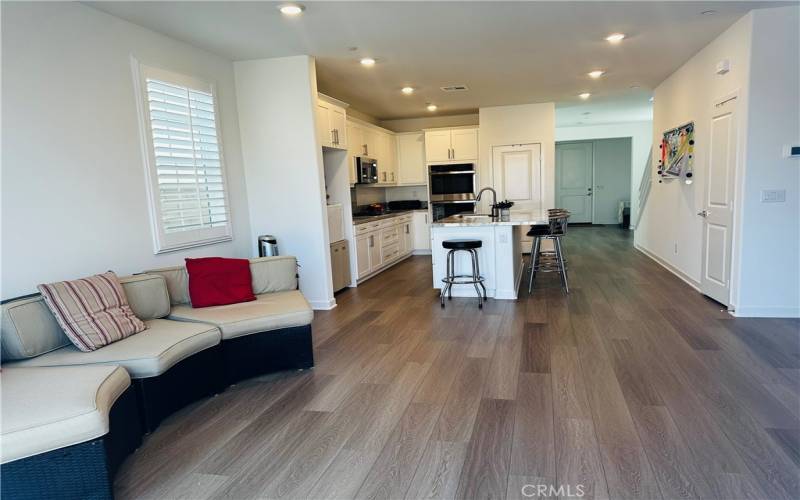 View of living room, kitchen and front door