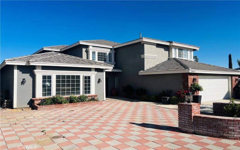 Checkerboard concrete tile in front can be used for extra parking