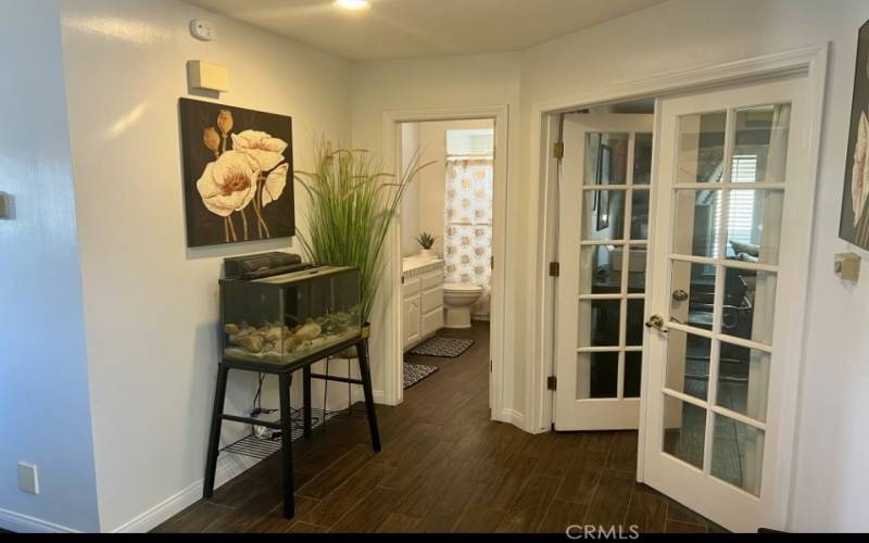 Hallway into downstairs bathroom and office/den