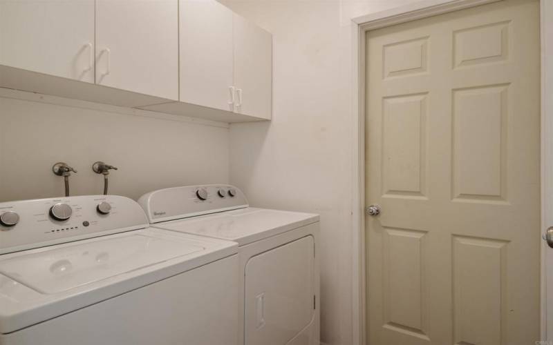 Washer and Dryer (Whirlpool) located beside the garage door