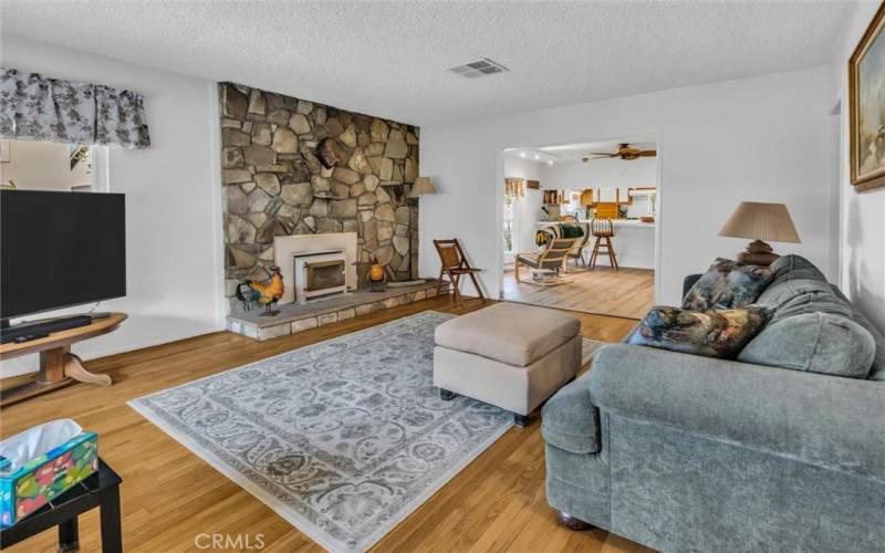 Living room with stone fireplace and wood burning insert