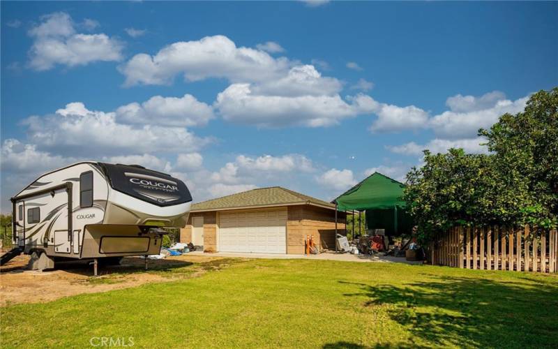 Back side of property showing parking area for larger RV's and detached two car garage