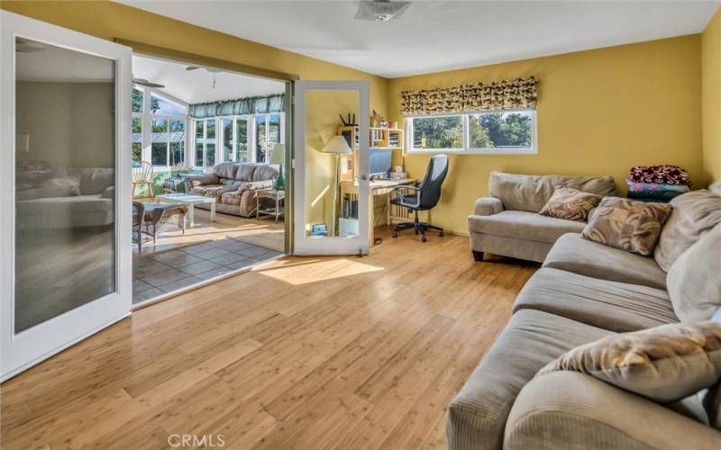 Third bedroom being utilized as a den/office with french doors leading to the sunroom