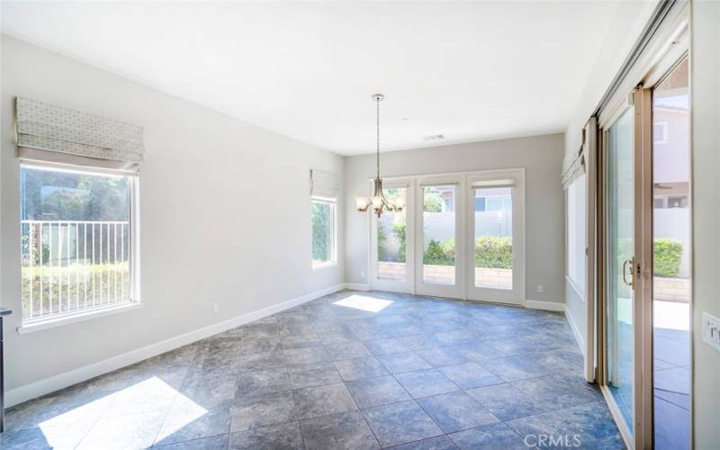 Kitchen dining area. Sliding door to patio, cheery room.