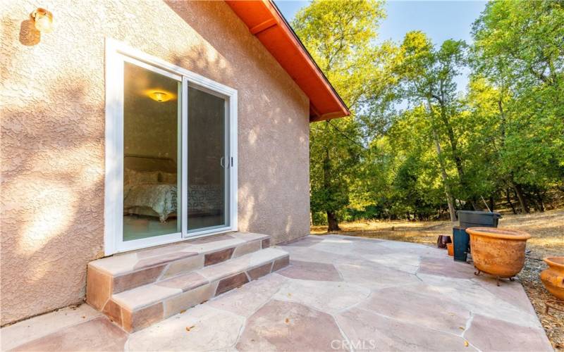 Imagine stepping out the primary bedroom slider to this beautiful back patio.