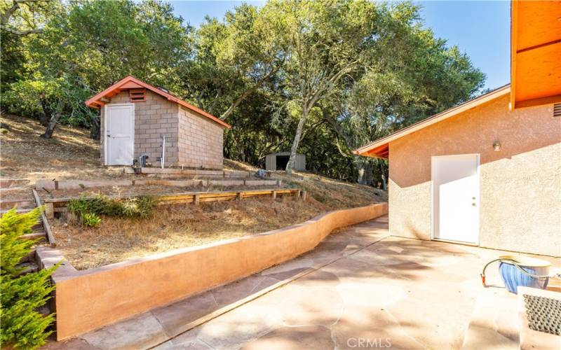 The back patio features attractive stamped concrete. The door leads into the garage.