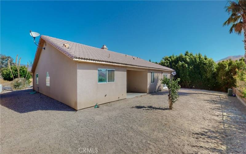 Rear yard with covered patio in center